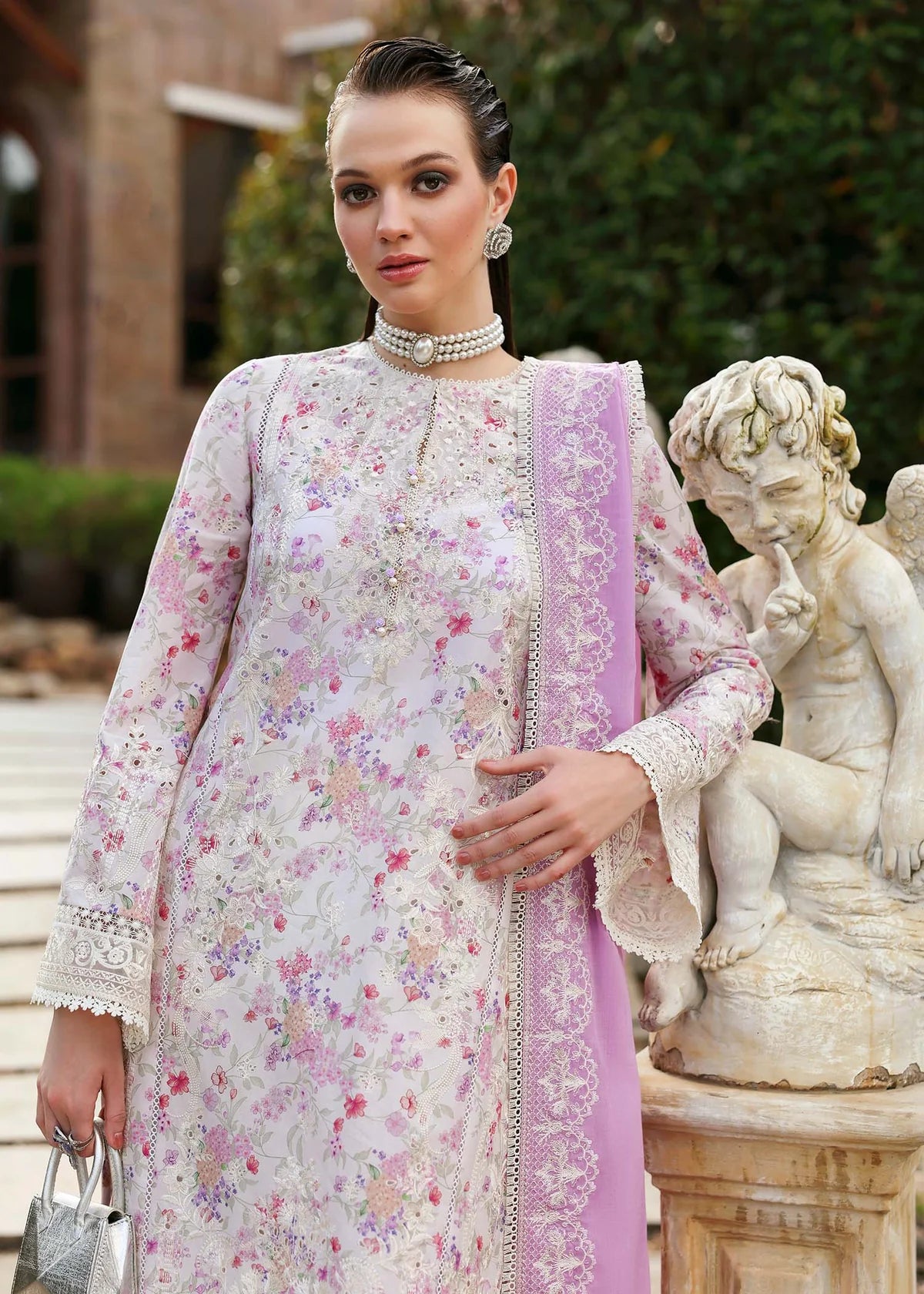 Model wearing pastel pink and white floral Raya dress from Kanwal Malik Zaina Lawn '25, Pakistani luxury pret for online shoppers in UK.