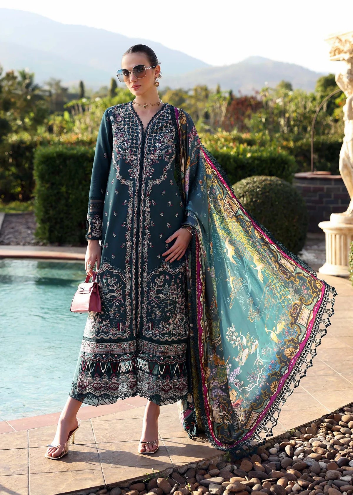 Model wearing deep teal embroidered Livia dress from Kanwal Malik Zaina Lawn '25, Pakistani luxury pret for online shoppers in UK.