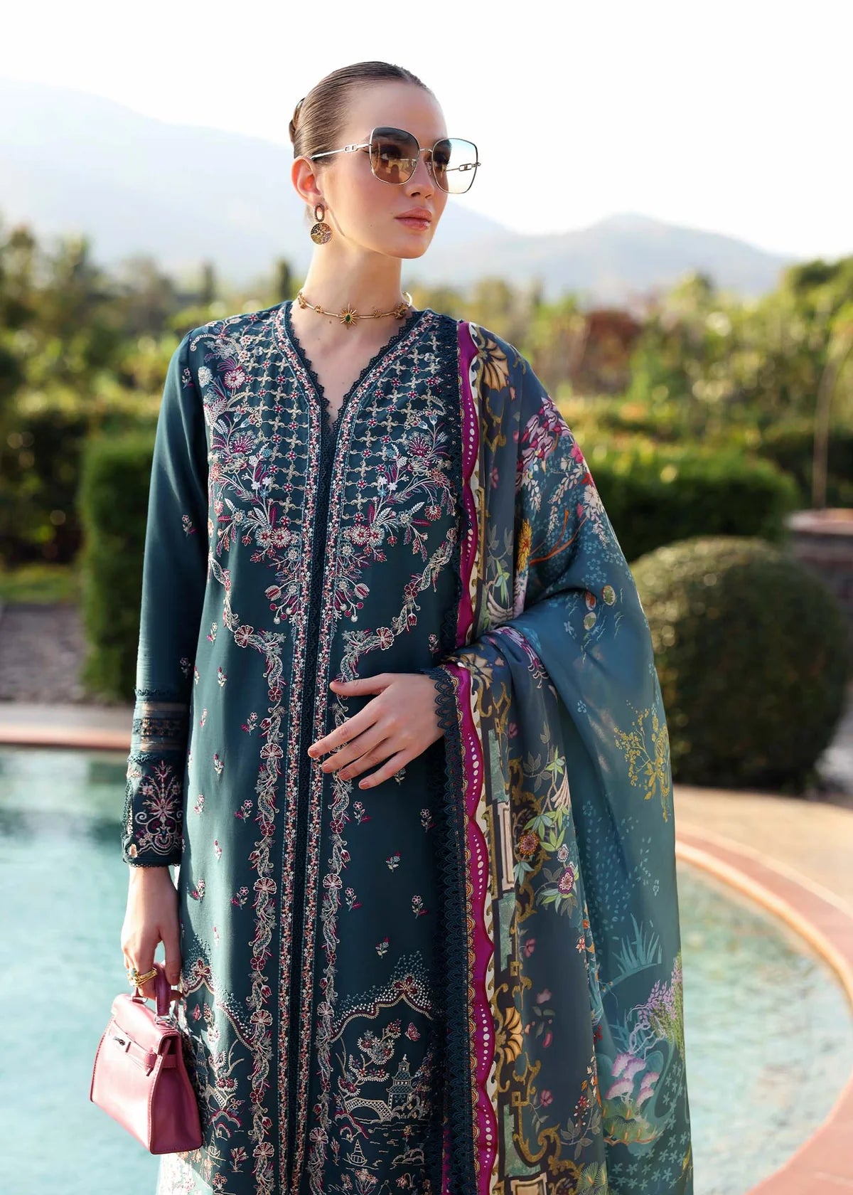 Model wearing deep teal embroidered Livia dress from Kanwal Malik Zaina Lawn '25, Pakistani luxury pret for online shoppers in UK.