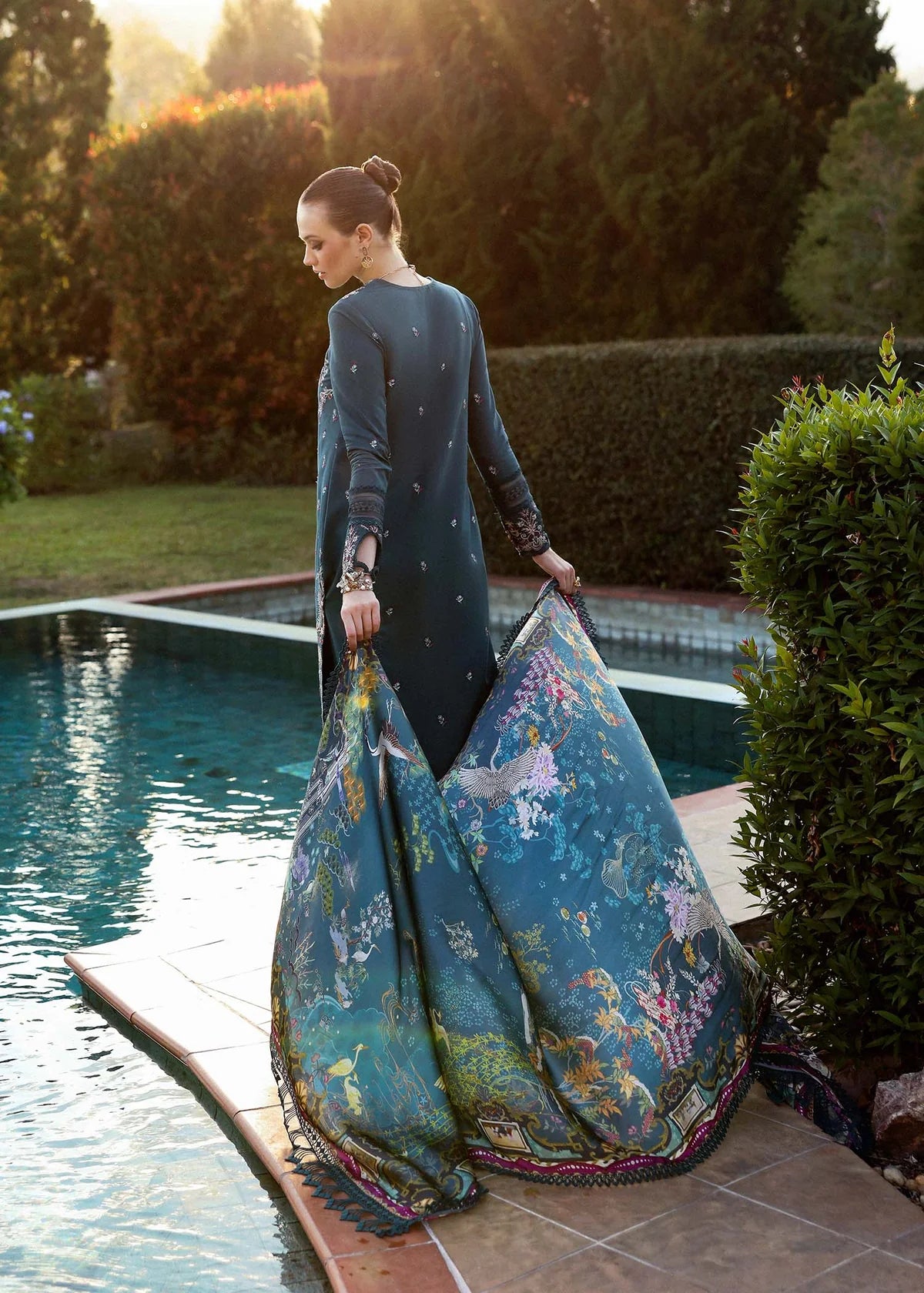 Model wearing deep teal embroidered Livia dress from Kanwal Malik Zaina Lawn '25, Pakistani luxury pret for online shoppers in UK.