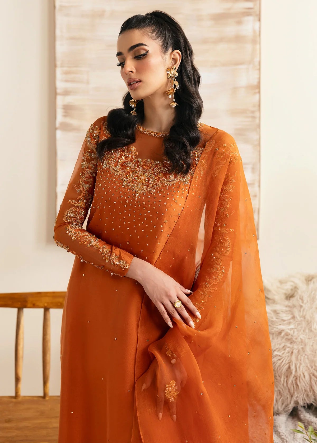 Model wearing Kanwal Malik Celina orange luxury pret dress. Shop Pakistani clothes online in the UK for festive and casual wear.