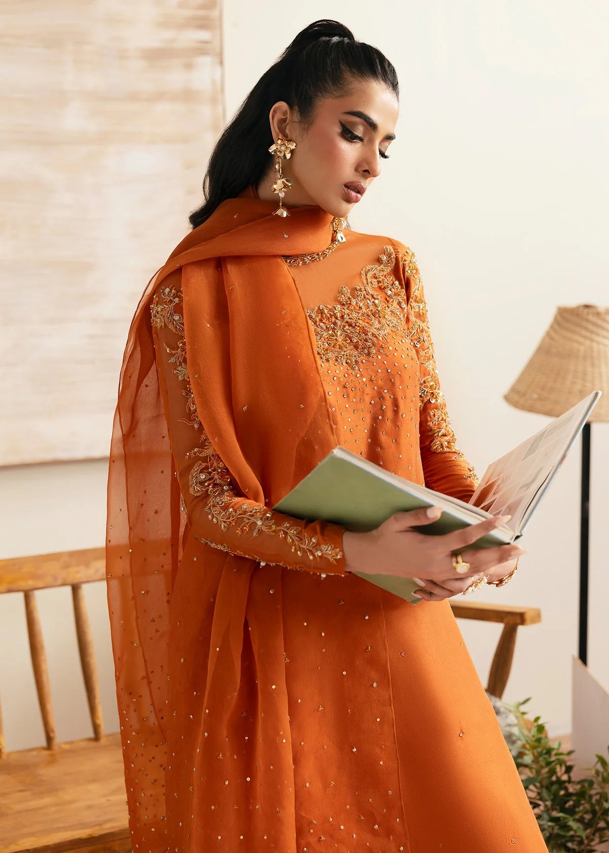 Model wearing Kanwal Malik Celina orange luxury pret dress. Shop Pakistani clothes online in the UK for festive and casual wear.