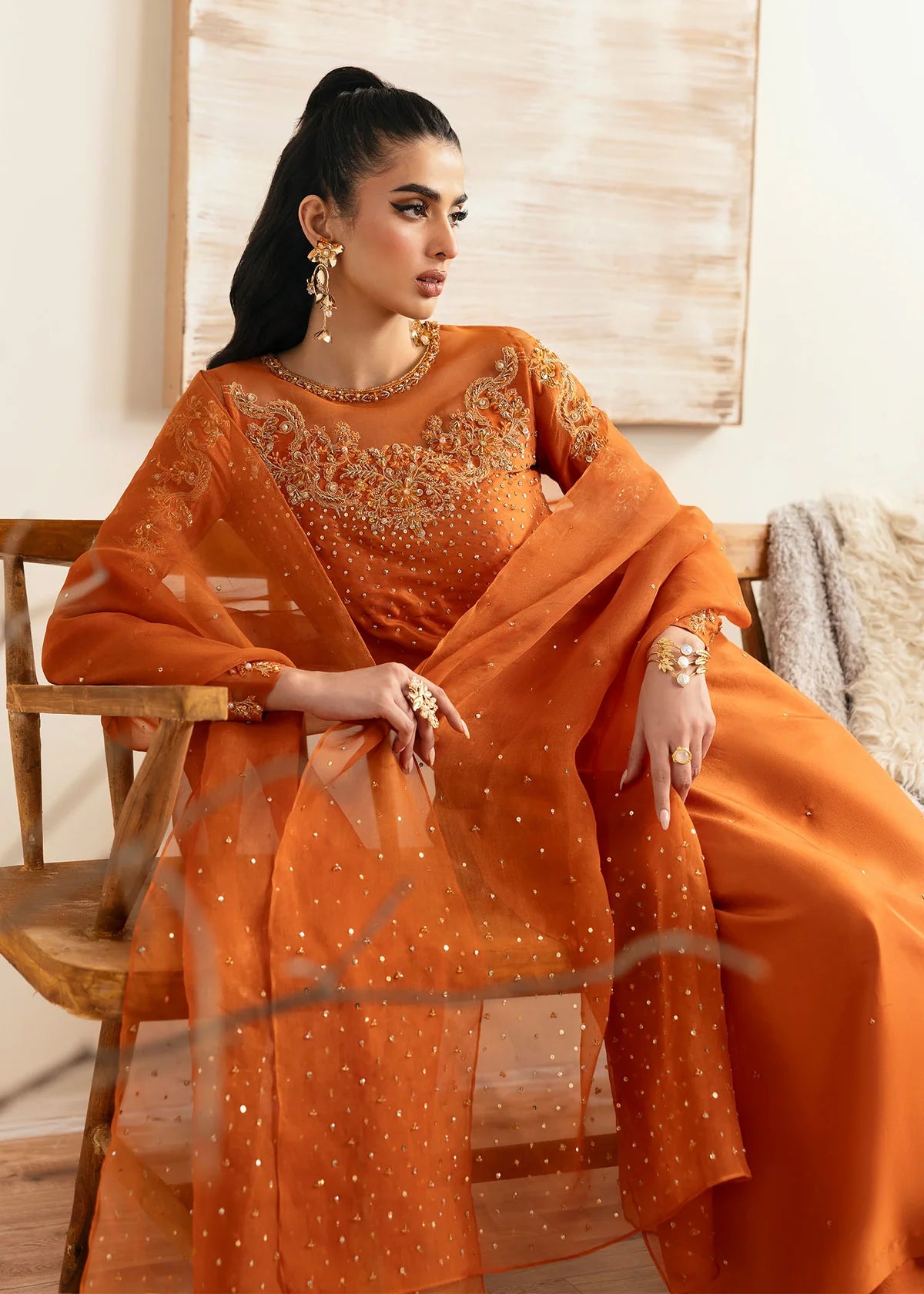Model wearing Kanwal Malik Celina orange luxury pret dress. Shop Pakistani clothes online in the UK for festive and casual wear.