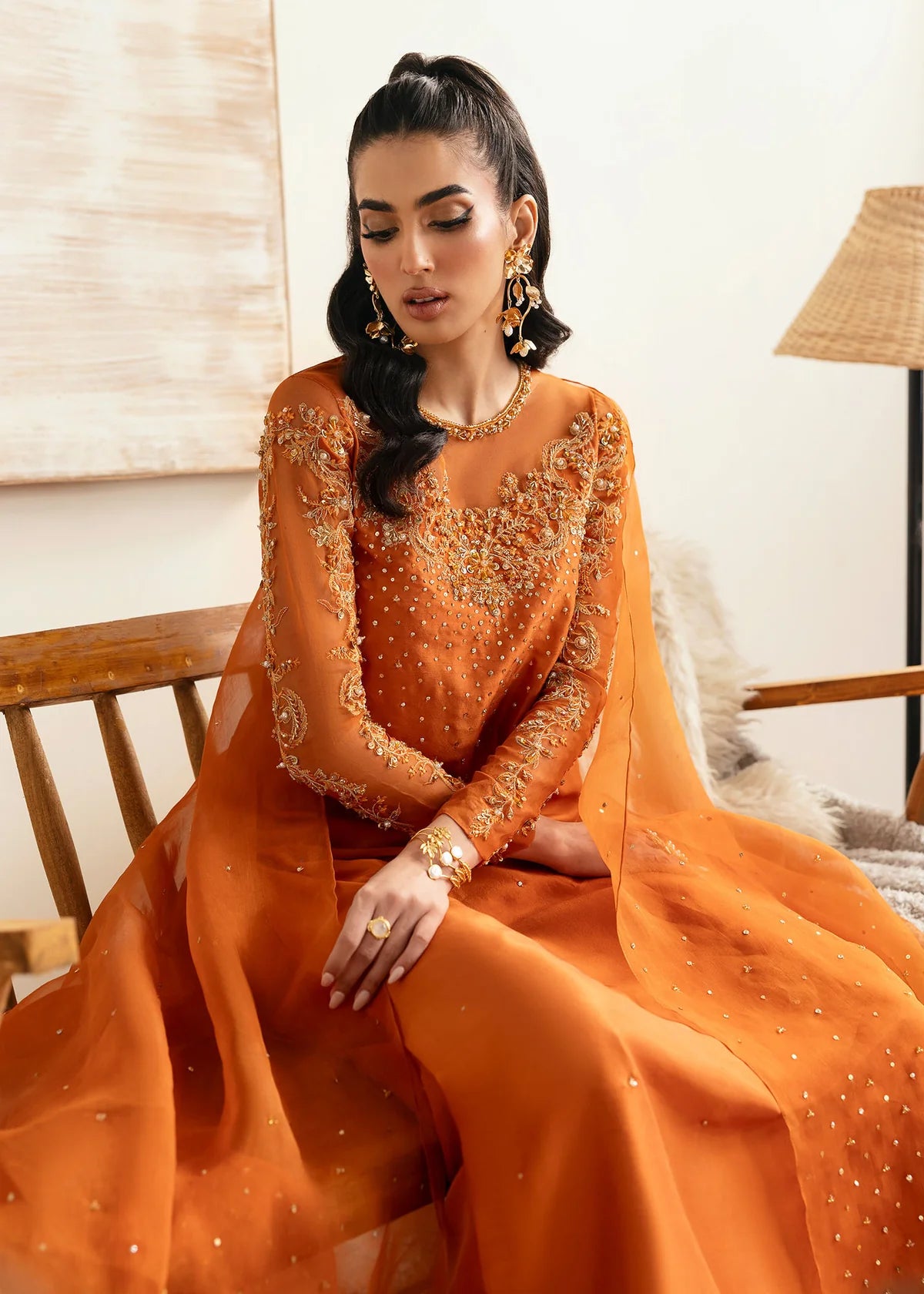 Model wearing Kanwal Malik Celina orange luxury pret dress. Shop Pakistani clothes online in the UK for festive and casual wear.