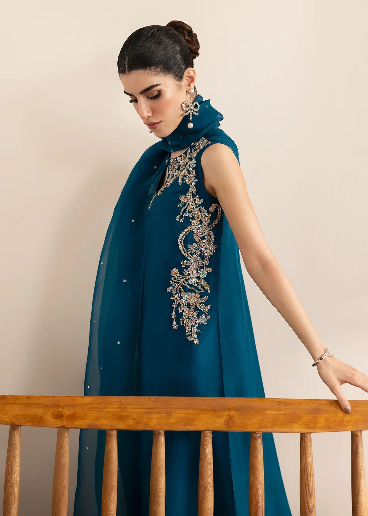 Model wearing Kanwal Malik Erina teal blue luxury pret dress. Shop Pakistani clothes online in the UK for festive and casual wear.