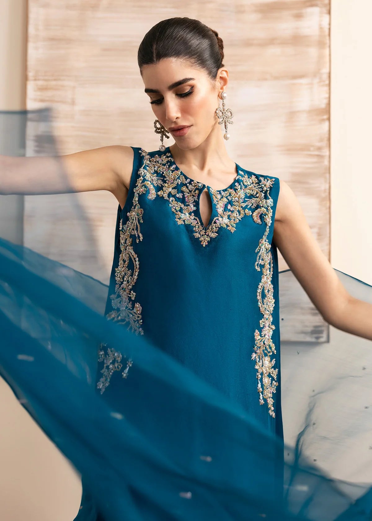 Model wearing Kanwal Malik Erina teal blue luxury pret dress. Shop Pakistani clothes online in the UK for festive and casual wear.