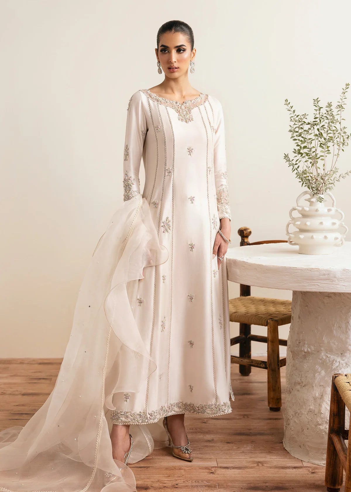 Model wearing Kanwal Malik Freya ivory embroidered luxury pret dress. Shop Pakistani clothes online in the UK for elegant occasion wear.