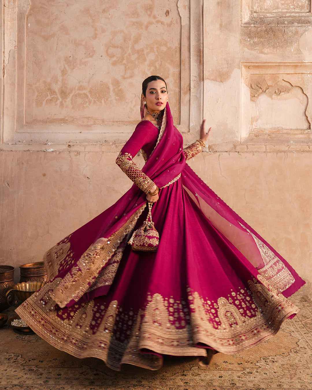 Model wearing deep burgundy pishwas with gold embroidery from Faiza Saqlain, Pakistani Luxury pret, Pakistani clothes online in UK.