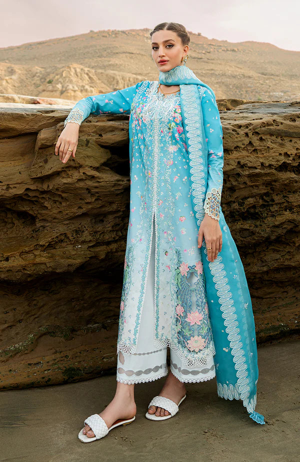 Model wearing aqua blue embroidered dress with white trousers and printed dupatta from Soraya Noa Summer Casual Pret 2025 Serenade. Pakistani luxury pret UK.