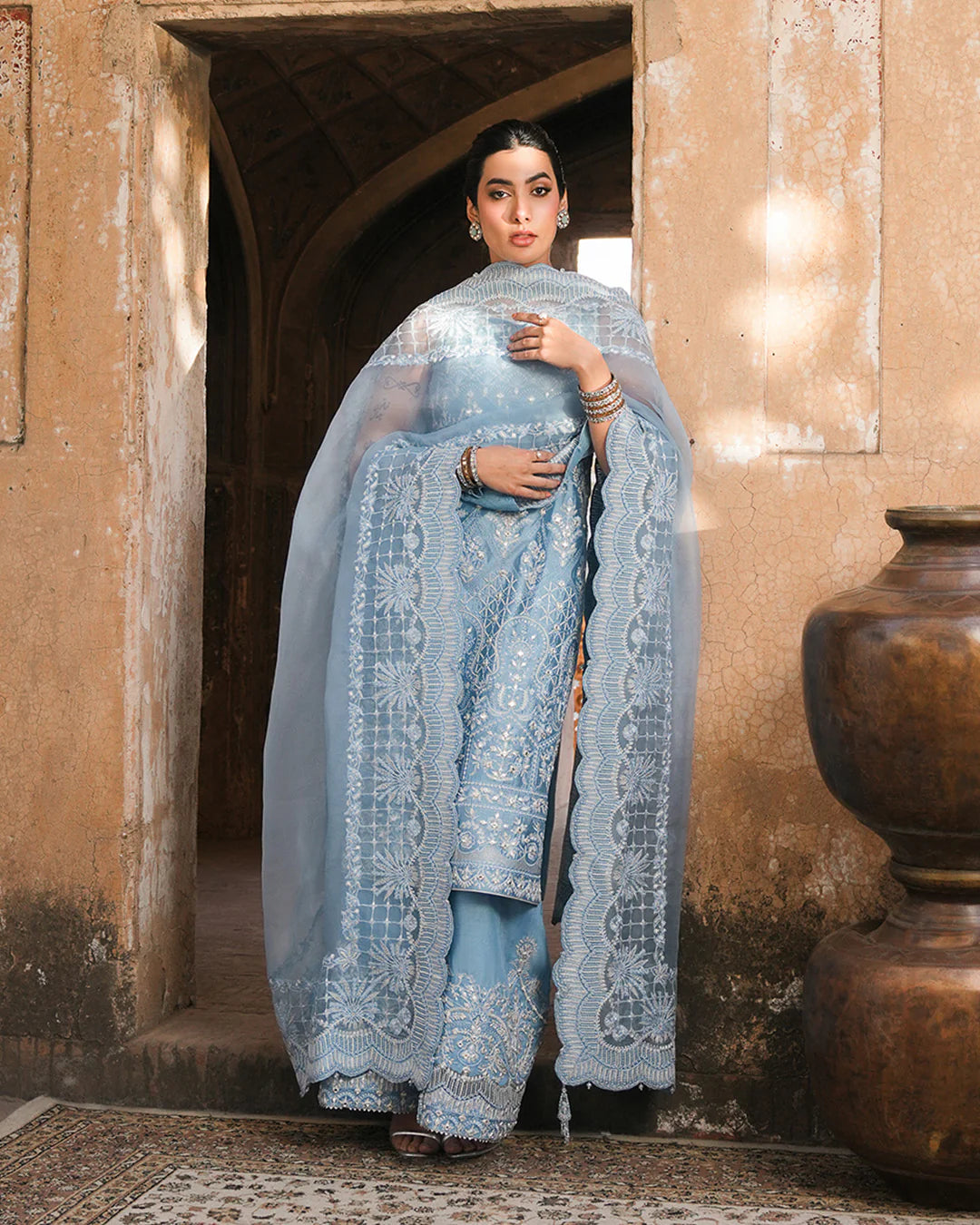 Model wearing powder blue Faiza Saqlain Yulia outfit with intricate embroidery and scalloped dupatta, ideal for Pakistani luxury pret in UK.