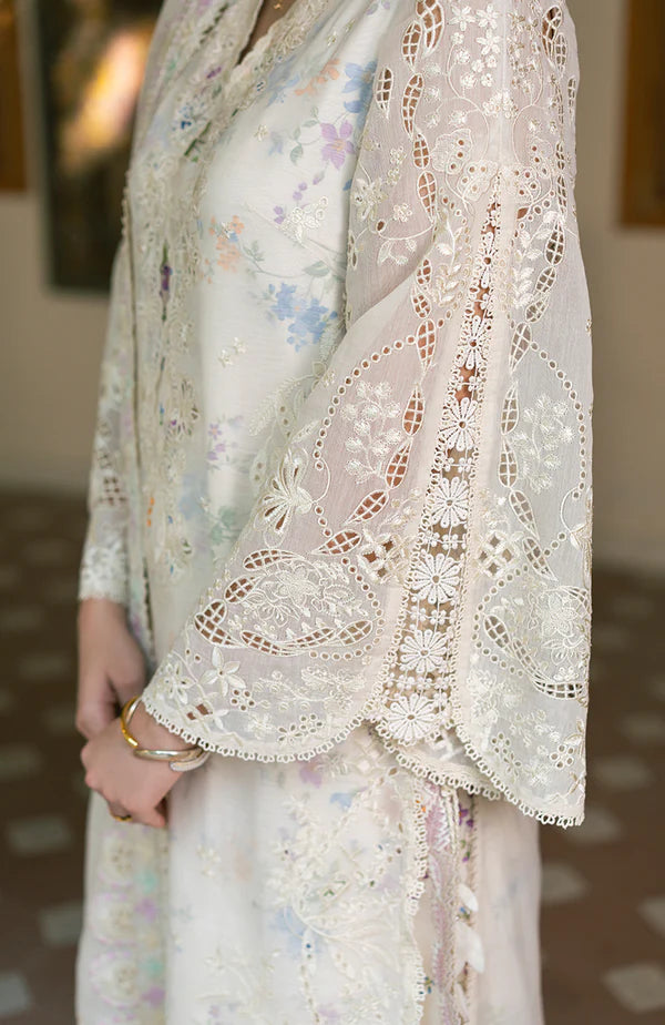 Model wearing off-white floral embroidered dress with lace sleeves and pastel accents from Soraya Noa Summer Casual Pret 2025 Bianca. Pakistani clothes online UK.