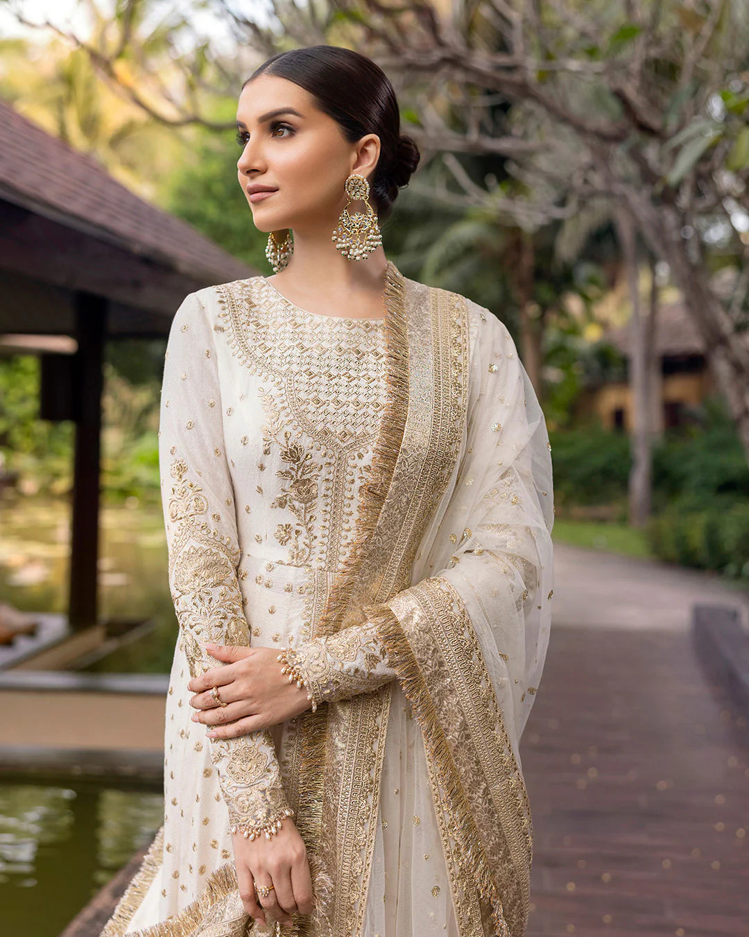 Model wearing ivory gold Lily dress from Faiza Saqlain Zinnia collection, Pakistani Luxury pret, Faiza Saqlain Pakistani clothes online in UK.