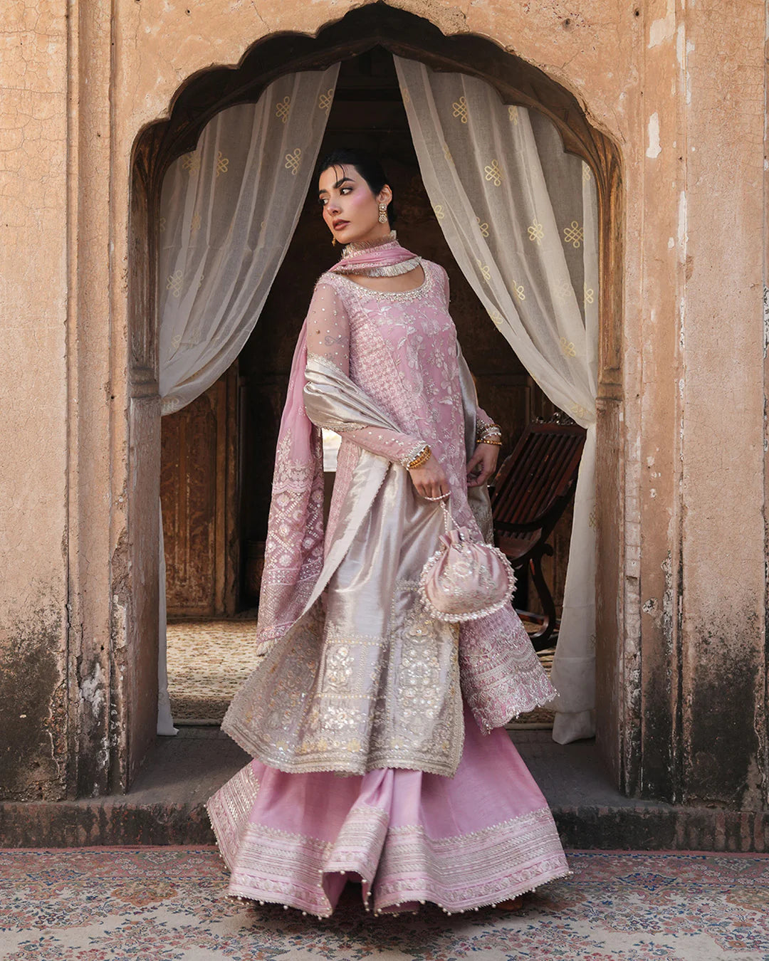 Model wearing blush pink Faiza Saqlain Vemita outfit with embellished detailing and dupatta, perfect for Pakistani luxury pret in the UK.