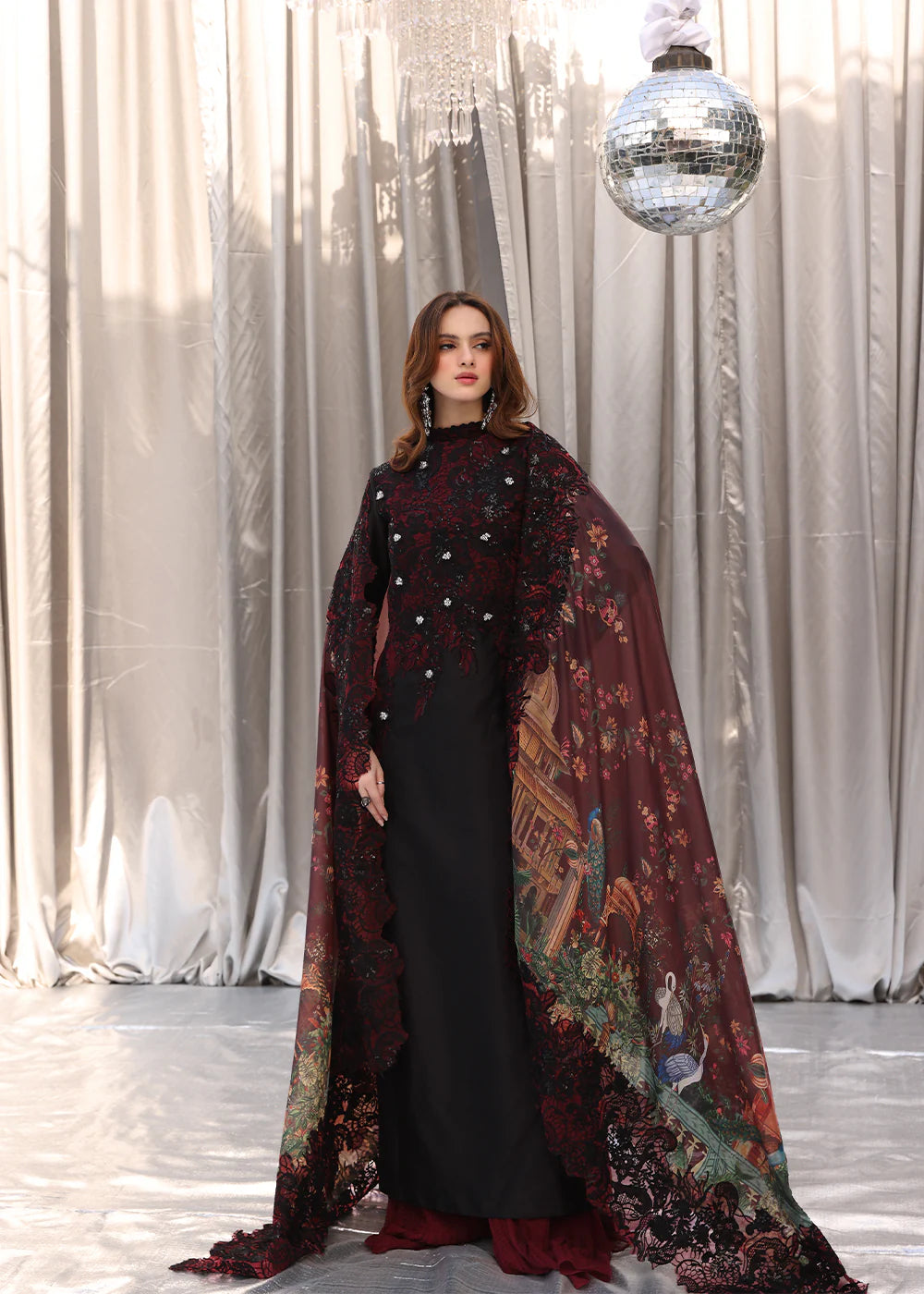 Model wearing black and deep red embroidered long dress with printed maroon dupatta from Musferah Saad Moonlit Glam, Pakistani Luxury pret in UK.