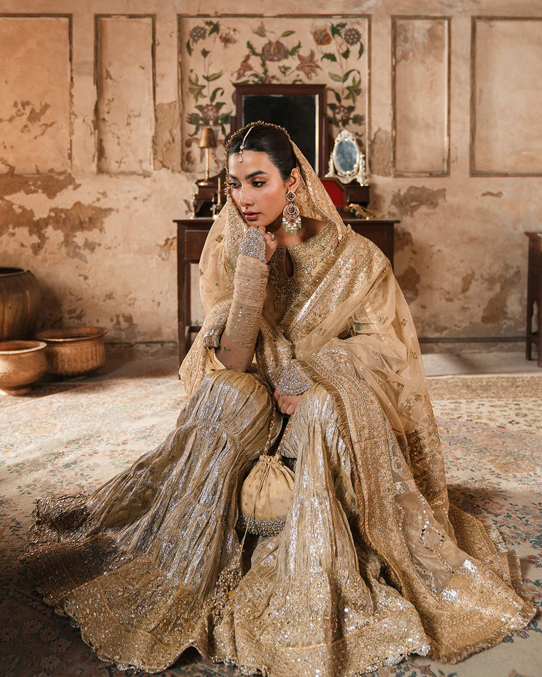 Model wearing gold Faiza Saqlain Camillie outfit with heavy embellishment, perfect for Pakistani luxury pret and festive wear in the UK.