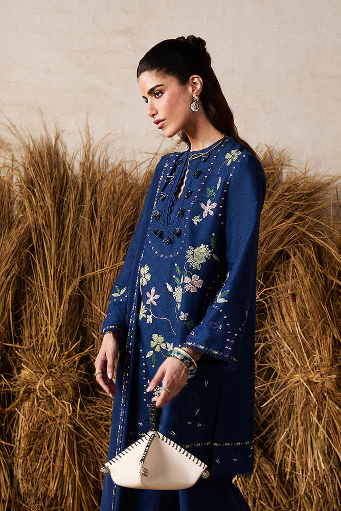 Model wearing Lazeh by Suffuse in deep navy blue with floral embroidery – elegant Pakistani luxury pret outfit in UK.