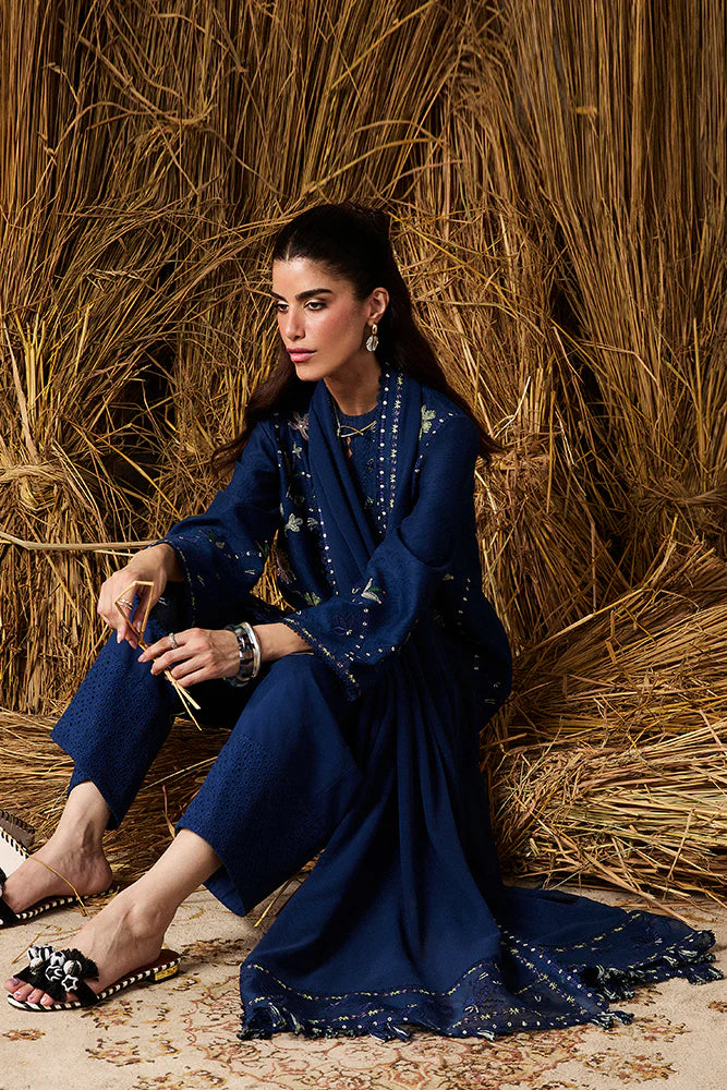 Model wearing Lazeh by Suffuse in deep navy blue with floral embroidery – elegant Pakistani luxury pret outfit in UK.