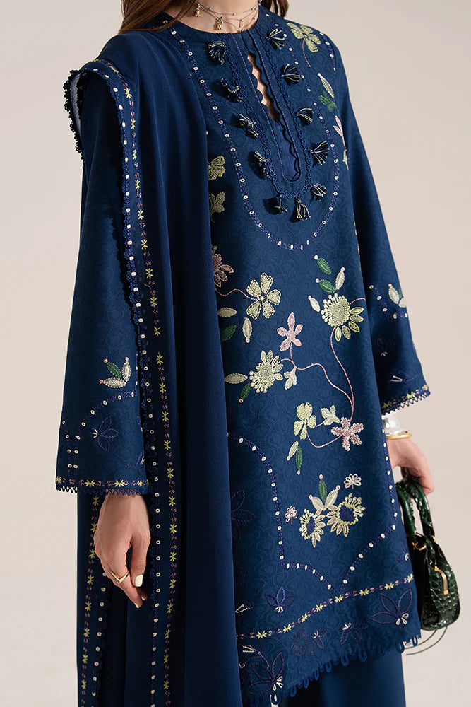 Model wearing Lazeh by Suffuse in deep navy blue with floral embroidery – elegant Pakistani luxury pret outfit in UK.
