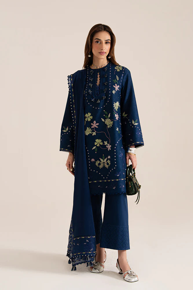 Model wearing Lazeh by Suffuse in deep navy blue with floral embroidery – elegant Pakistani luxury pret outfit in UK.