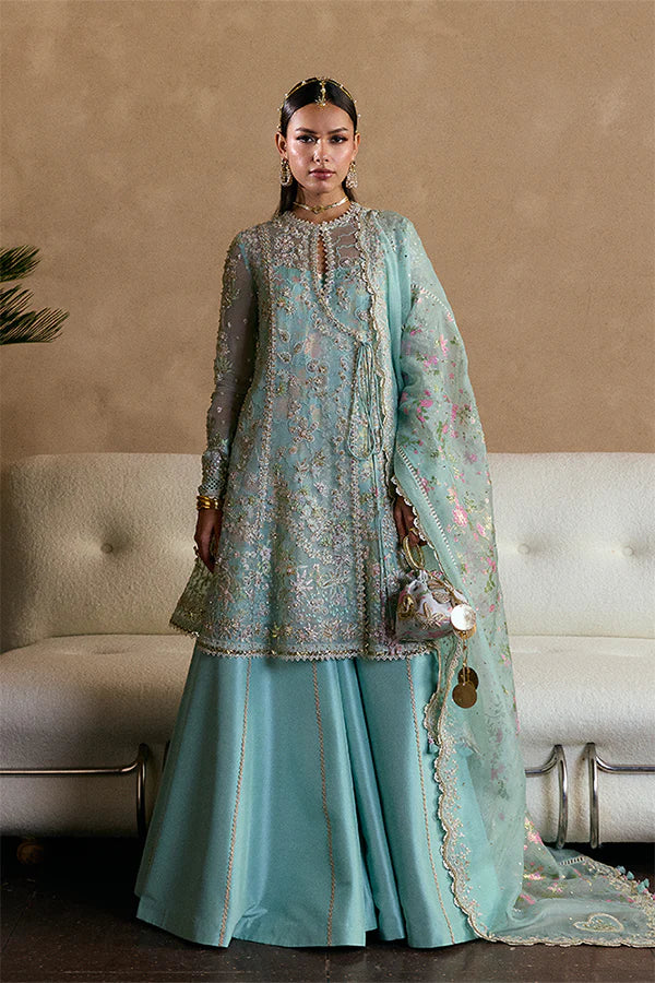 Model wearing aqua blue embellished ensemble from Suffuse Illyra, Pakistani luxury pret, shop Pakistani clothes online in UK
