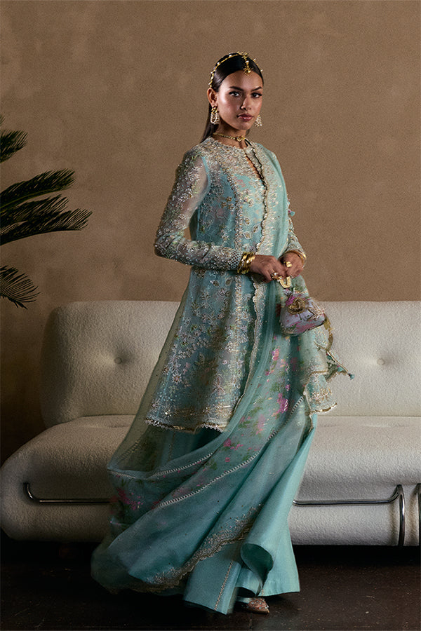 Model wearing aqua blue embellished ensemble from Suffuse Illyra, Pakistani luxury pret, shop Pakistani clothes online in UK