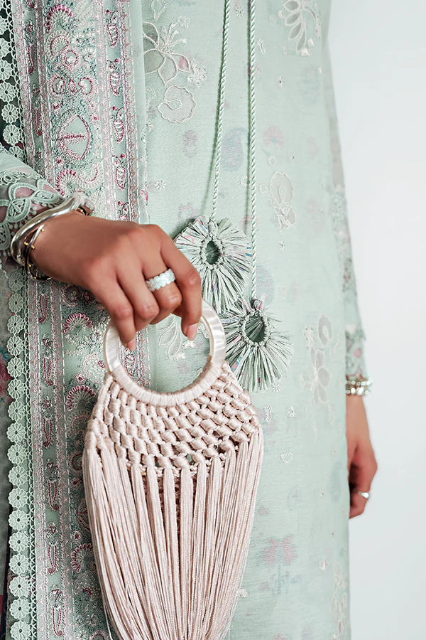 Model wearing pastel mint green embroidered dress from Suffuse Casual Pret 2025 Naire. Pakistani luxury pret and Pakistani clothes online in UK.