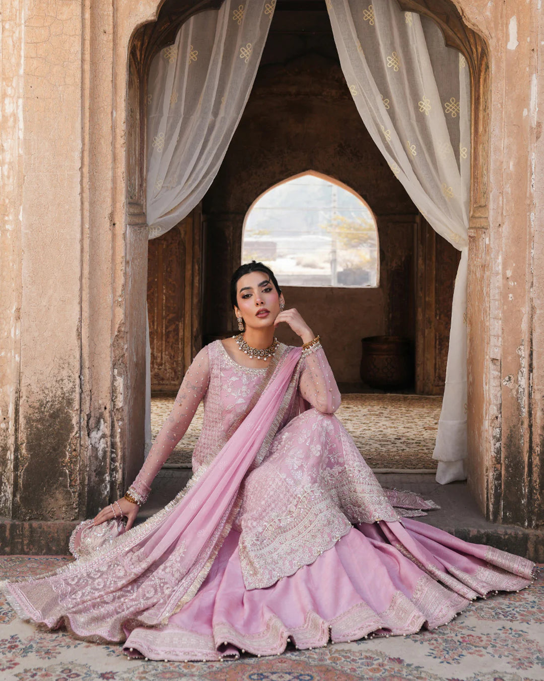 Model wearing blush pink Faiza Saqlain Vemita outfit with embellished detailing and dupatta, perfect for Pakistani luxury pret in the UK.