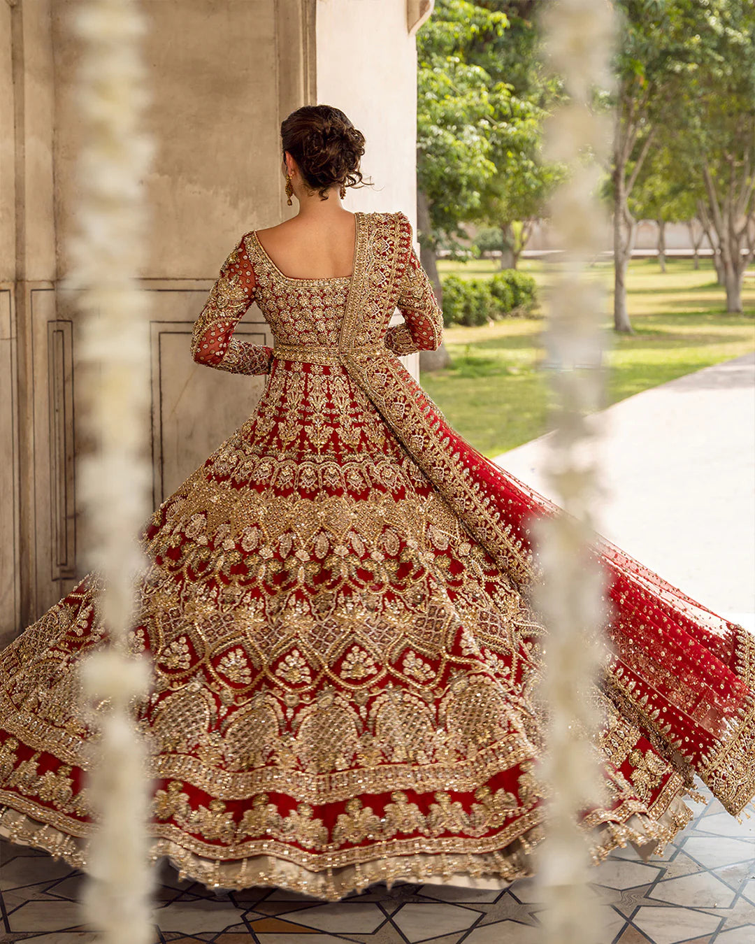 Model wearing deep red and gold bridal dress Juri by Faiza Saqlain, Pakistani luxury pret online in UK for weddings.