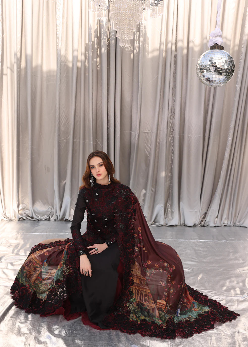 Model wearing black and deep red embroidered long dress with printed maroon dupatta from Musferah Saad Moonlit Glam, Pakistani Luxury pret in UK.