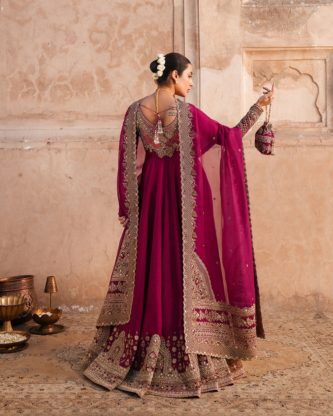 Model wearing deep burgundy pishwas with gold embroidery from Faiza Saqlain, Pakistani Luxury pret, Pakistani clothes online in UK.