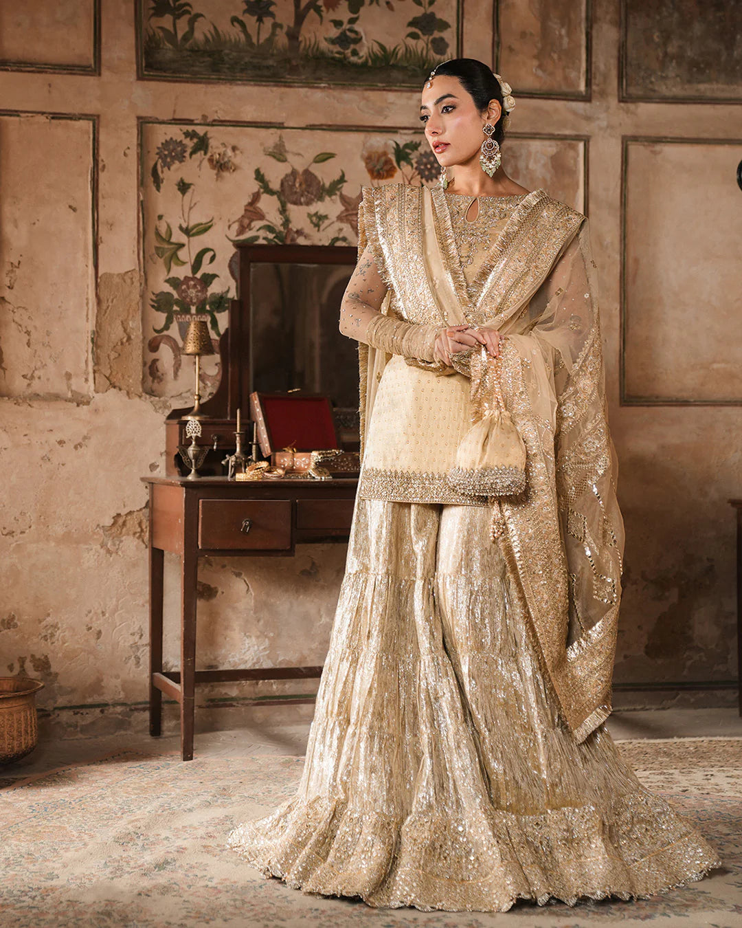 Model wearing gold Faiza Saqlain Camillie outfit with heavy embellishment, perfect for Pakistani luxury pret and festive wear in the UK.