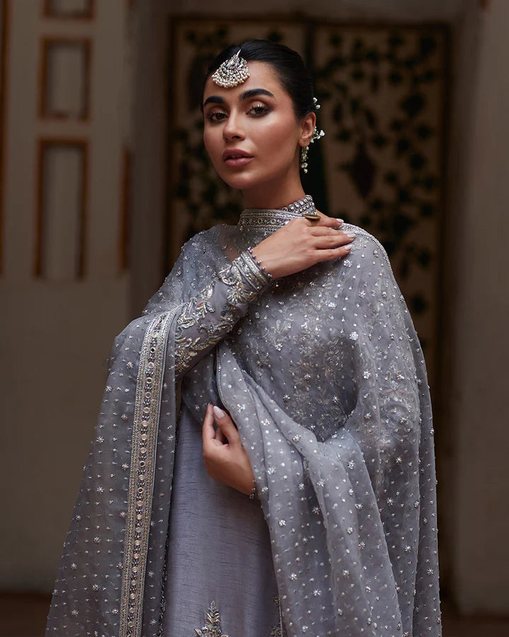 model wearing grey embroidered dress by Faiza Saqlain, Pakistani luxury pret available online in UK