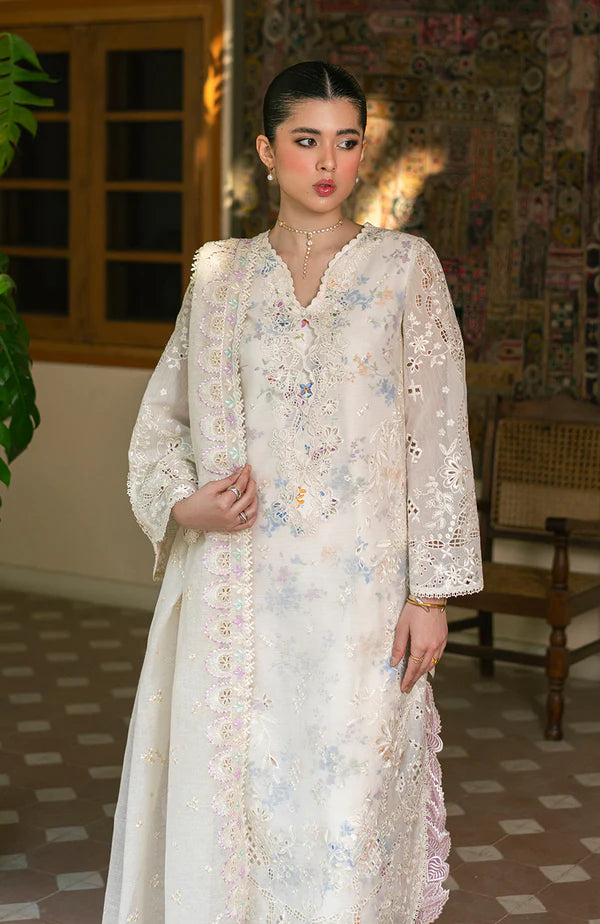 Model wearing off-white floral embroidered dress with lace sleeves and pastel accents from Soraya Noa Summer Casual Pret 2025 Bianca. Pakistani clothes online UK.