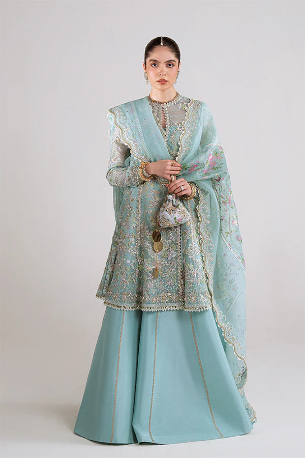 Model wearing aqua blue embellished ensemble from Suffuse Illyra, Pakistani luxury pret, shop Pakistani clothes online in UK