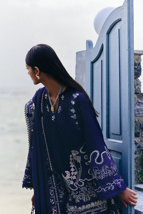 Model wearing deep navy blue embroidered dress with intricate detailing from Suffuse Casual Pret 2025 Sahra. Pakistani luxury pret in UK.