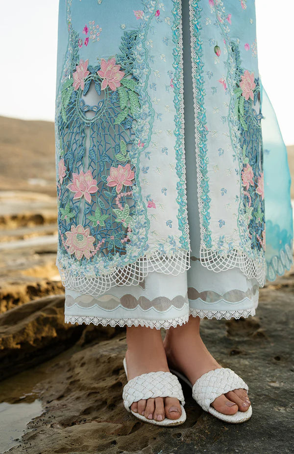 Model wearing aqua blue embroidered dress with white trousers and printed dupatta from Soraya Noa Summer Casual Pret 2025 Serenade. Pakistani luxury pret UK.