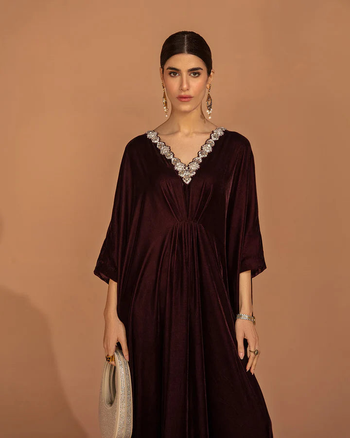Model wearing a burgundy Adiba dress from Faiza Saqlain's Aleira Evening Edit '24 collection. Pakistani clothes online in UK.