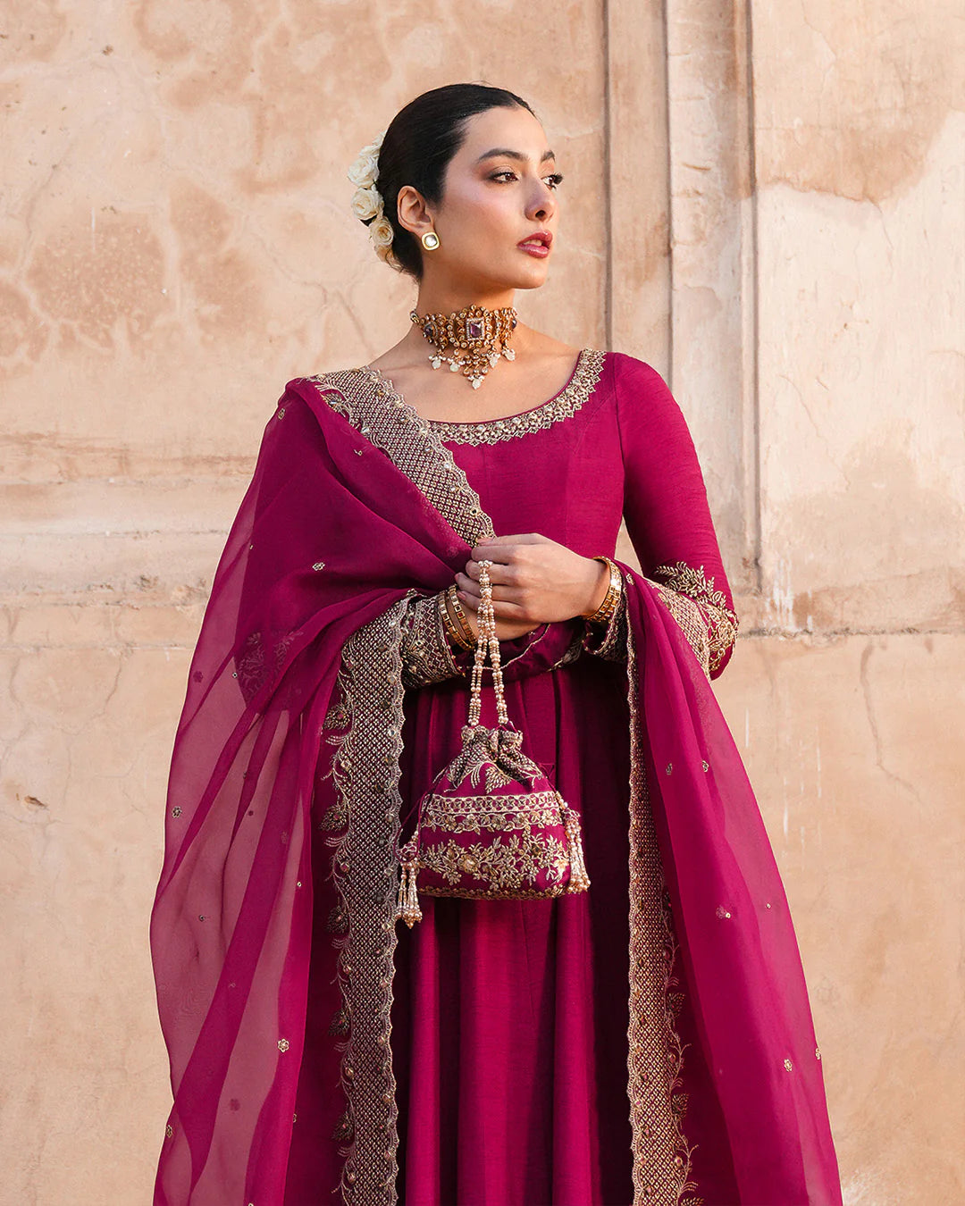 Model wearing deep burgundy pishwas with gold embroidery from Faiza Saqlain, Pakistani Luxury pret, Pakistani clothes online in UK.