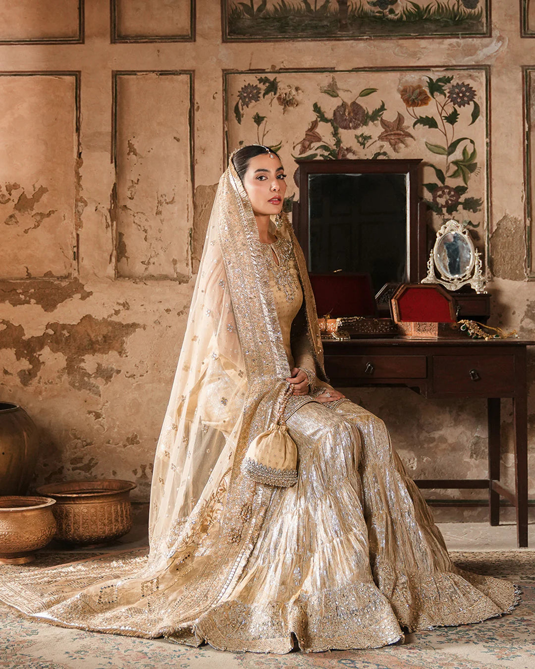 Model wearing gold Faiza Saqlain Camillie outfit with heavy embellishment, perfect for Pakistani luxury pret and festive wear in the UK.