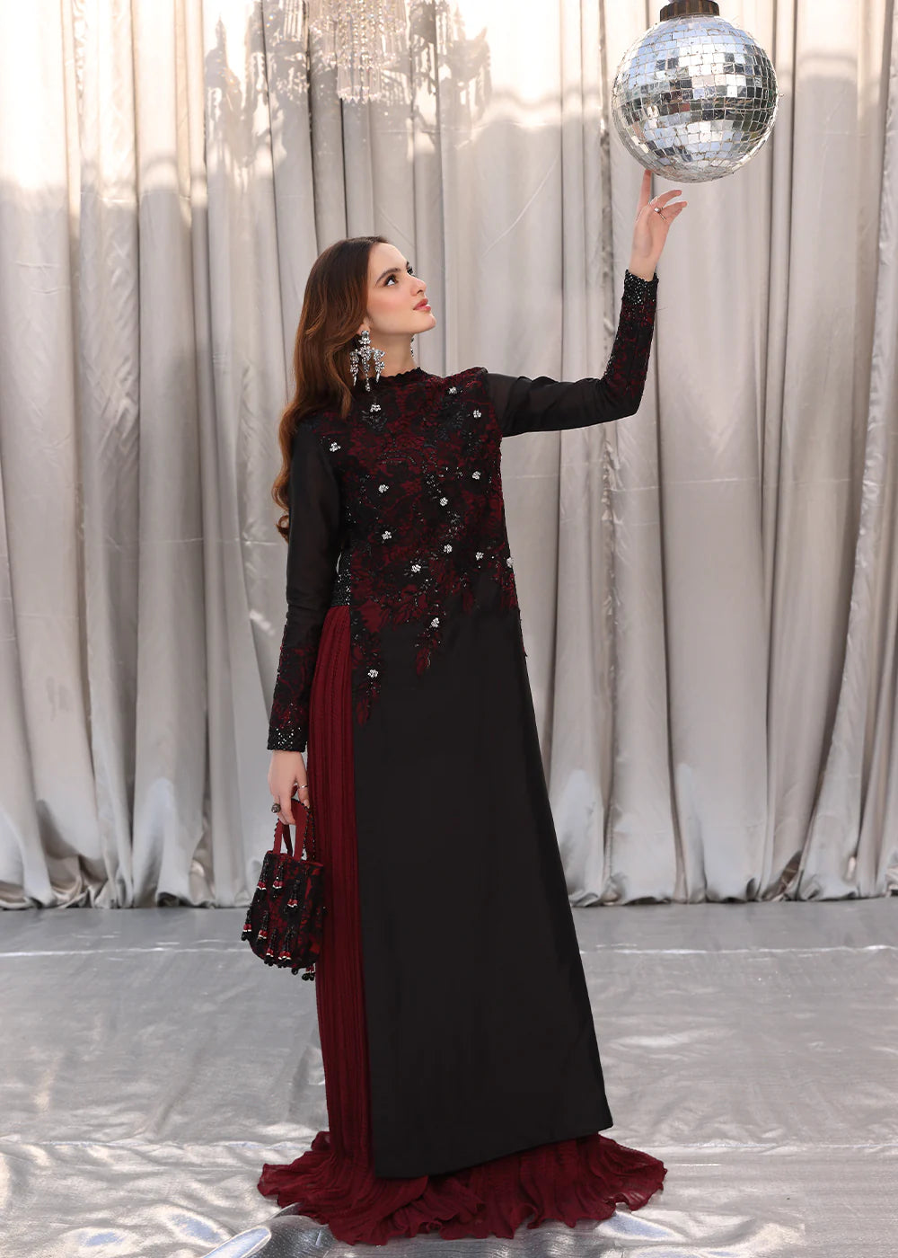 Model wearing black and deep red embroidered long dress with printed maroon dupatta from Musferah Saad Moonlit Glam, Pakistani Luxury pret in UK.