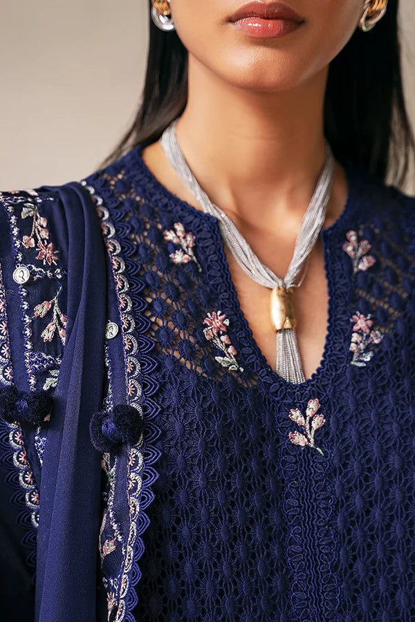 Model wearing deep navy blue embroidered dress with intricate detailing from Suffuse Casual Pret 2025 Sahra. Pakistani luxury pret in UK.