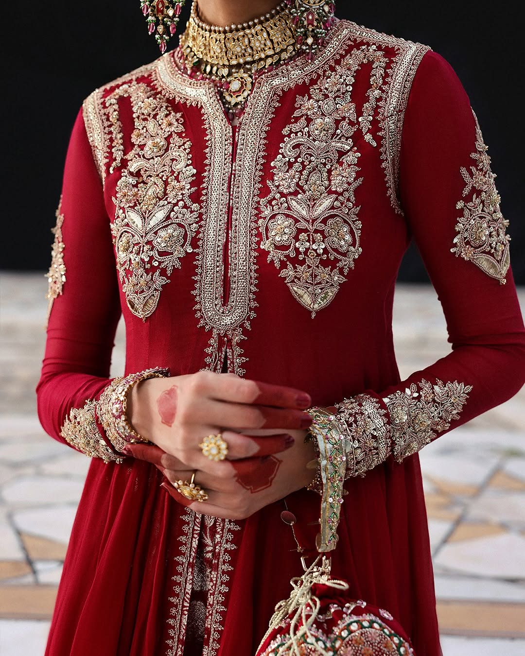 Model wearing Dilrubah by Hussain Rehar in deep red with gold embroidery – regal Pakistani luxury pret outfit in UK.