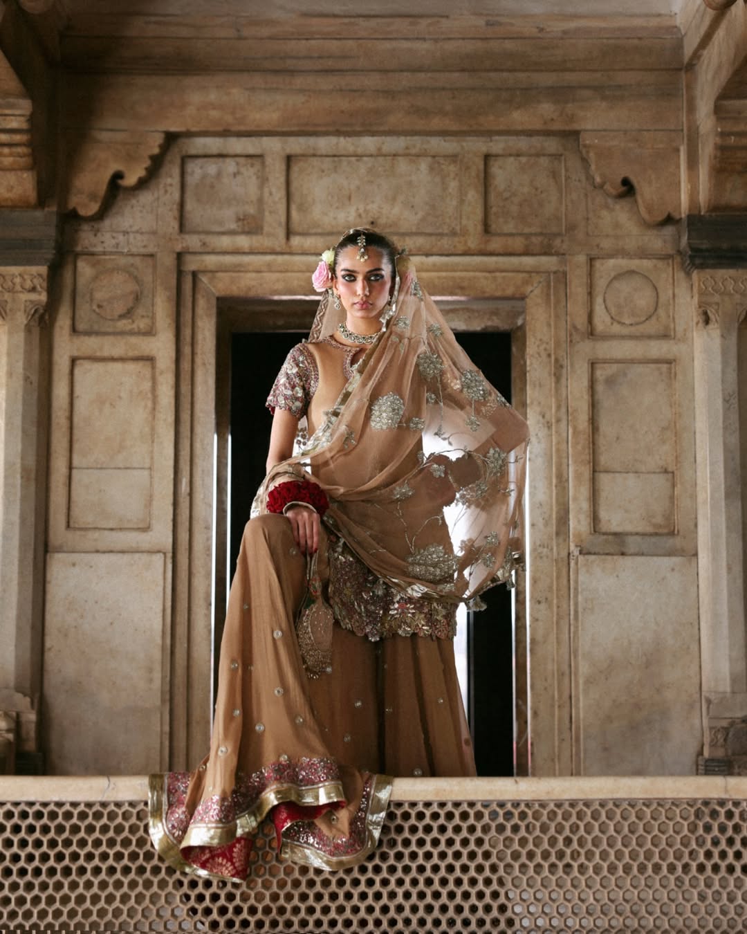 Model wearing Mehrab by Hussain Rehar in bronze with green and pink embroidery – opulent Pakistani luxury pret outfit in UK.
