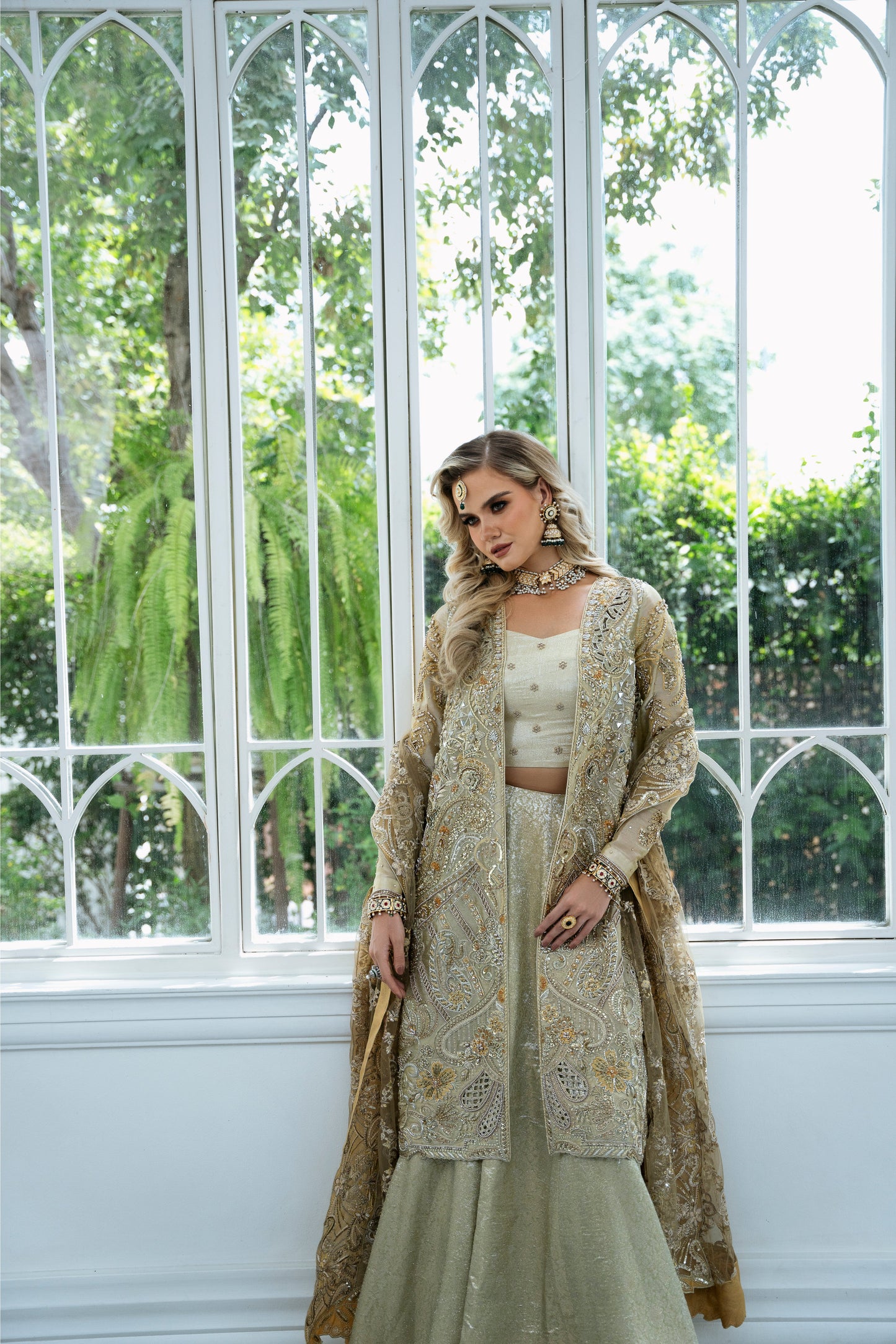 Model wearing Marigold from Mysie by Tahira, a golden-hued ensemble with intricate embroidery, ideal for Pakistani luxury pret in the UK.