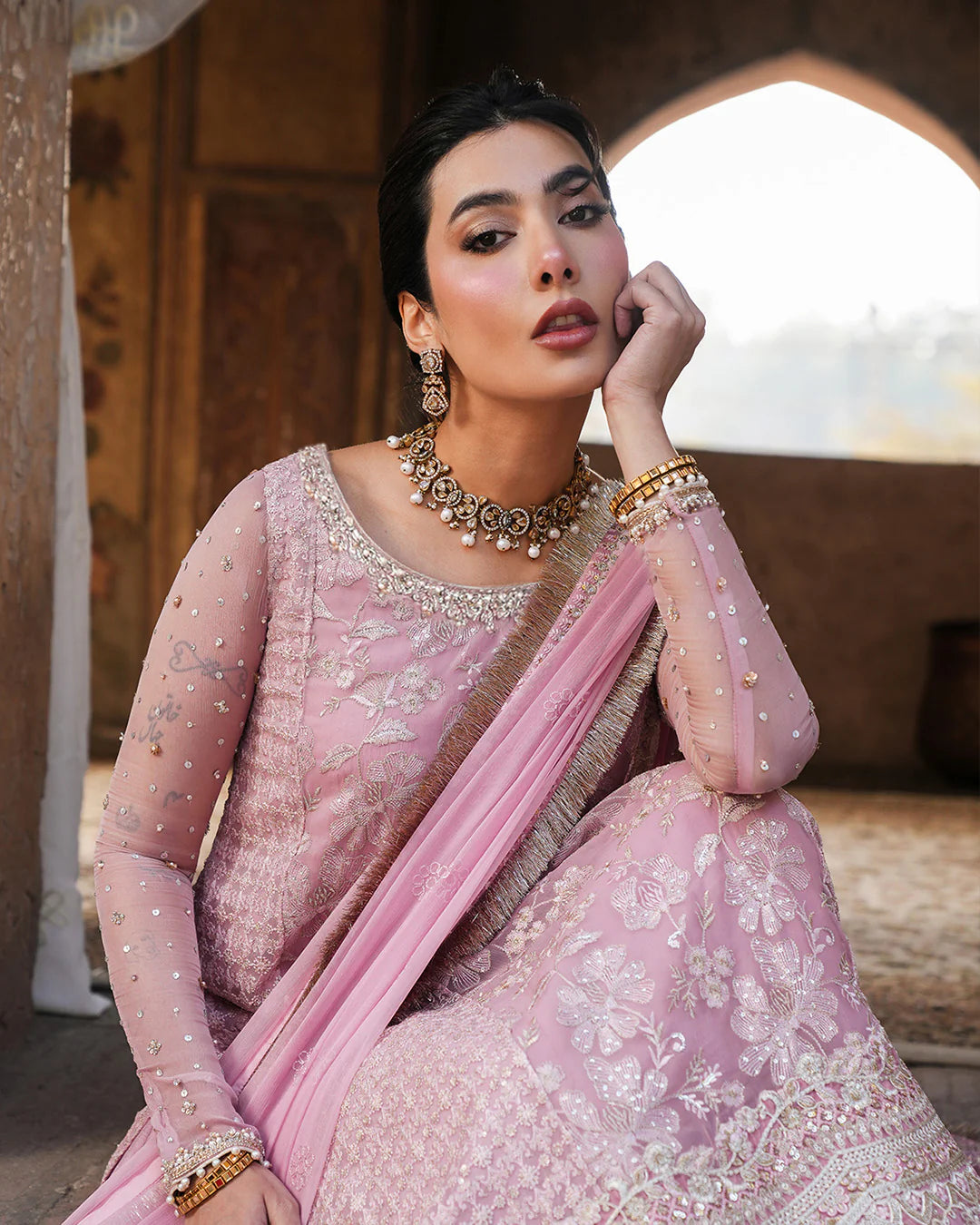 Model wearing blush pink Faiza Saqlain Vemita outfit with embellished detailing and dupatta, perfect for Pakistani luxury pret in the UK.