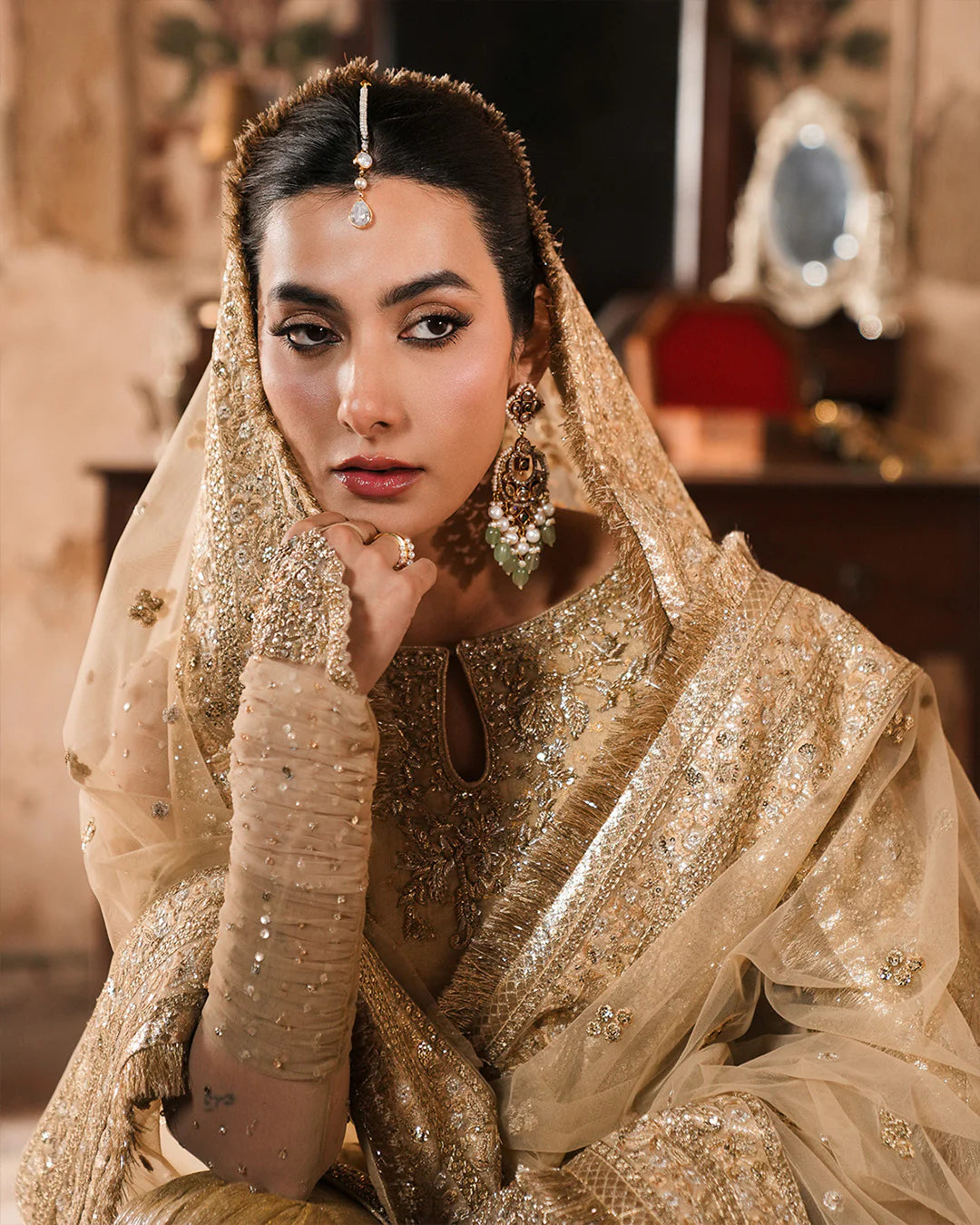 Model wearing gold Faiza Saqlain Camillie outfit with heavy embellishment, perfect for Pakistani luxury pret and festive wear in the UK.