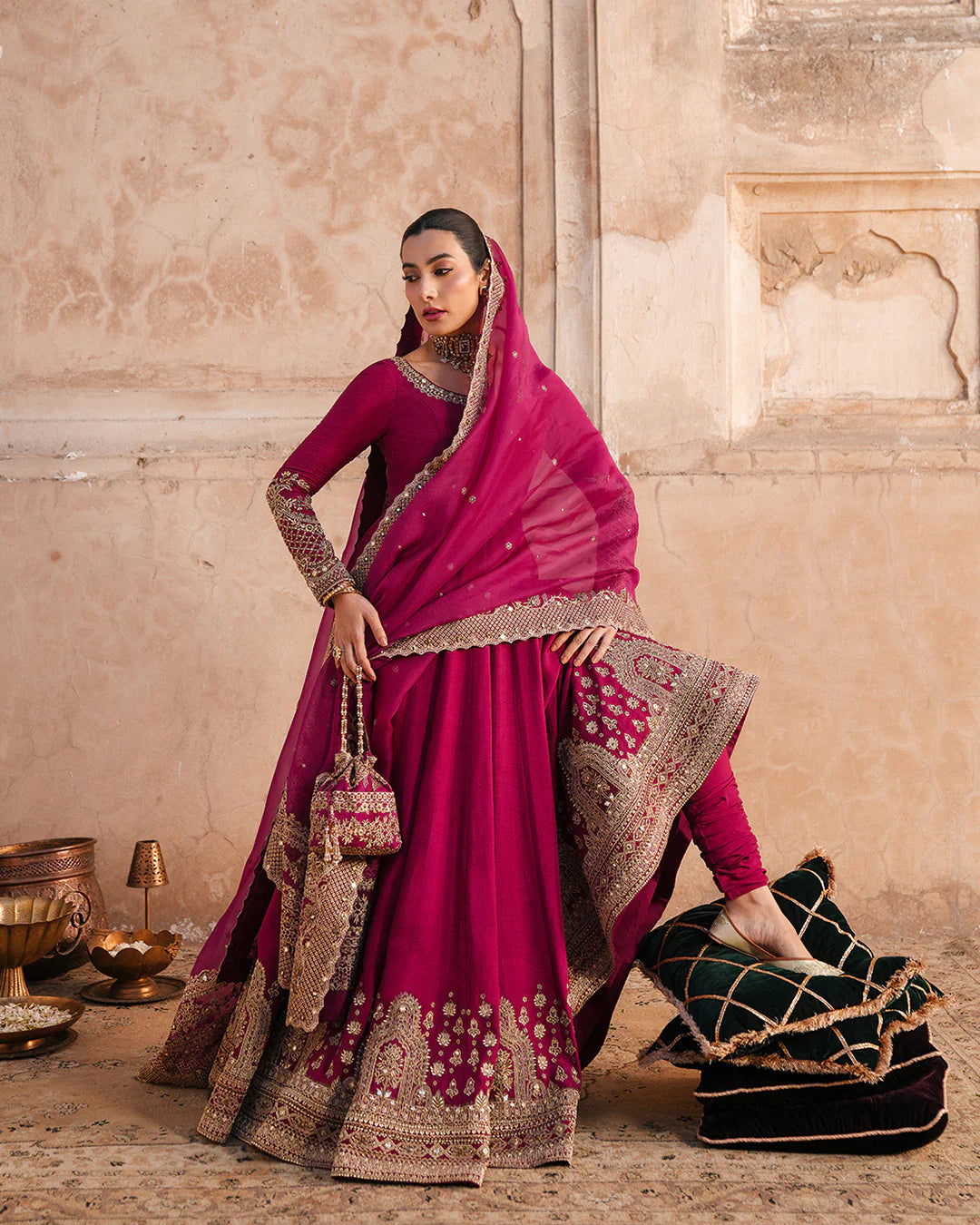 Model wearing deep burgundy pishwas with gold embroidery from Faiza Saqlain, Pakistani Luxury pret, Pakistani clothes online in UK.