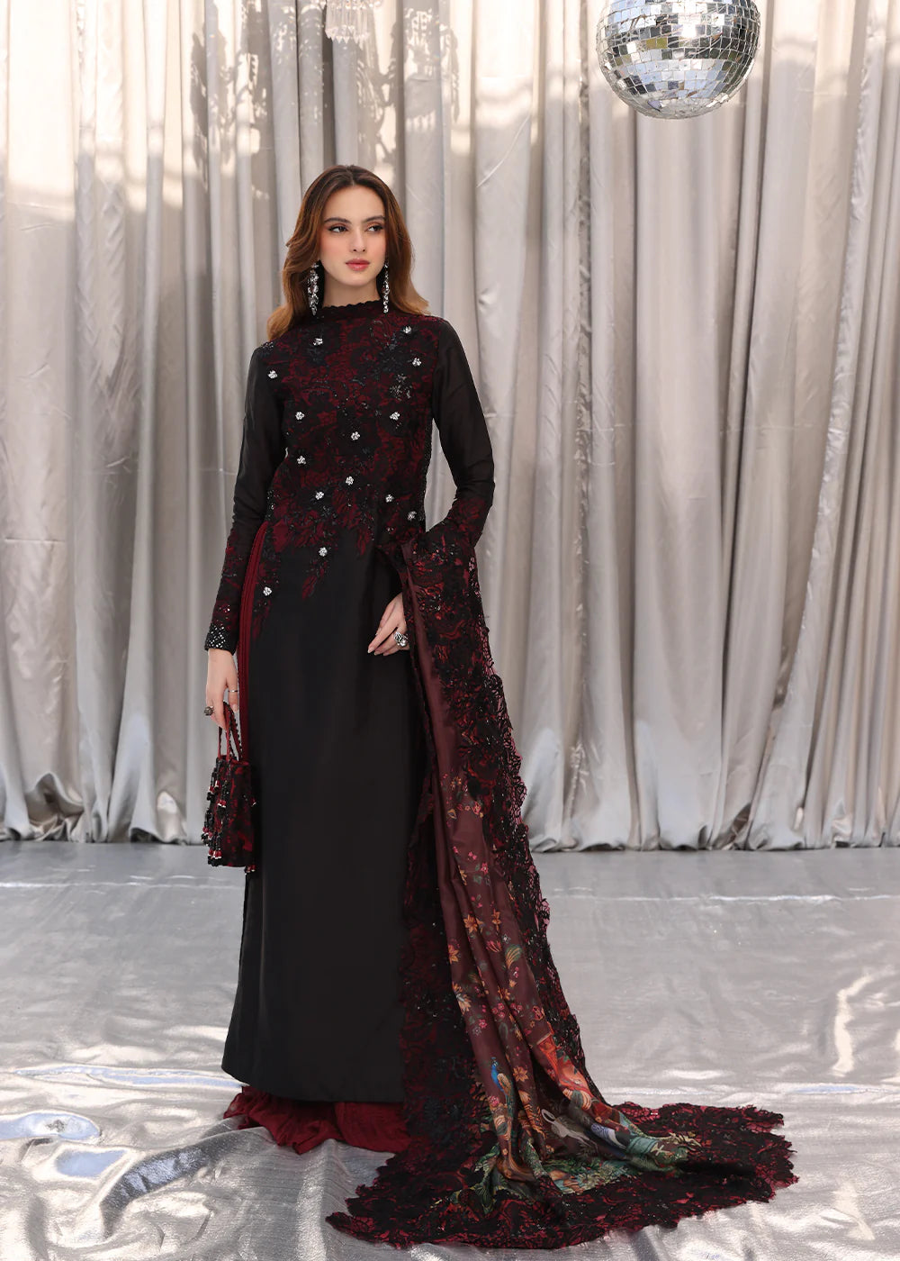 Model wearing black and deep red embroidered long dress with printed maroon dupatta from Musferah Saad Moonlit Glam, Pakistani Luxury pret in UK.