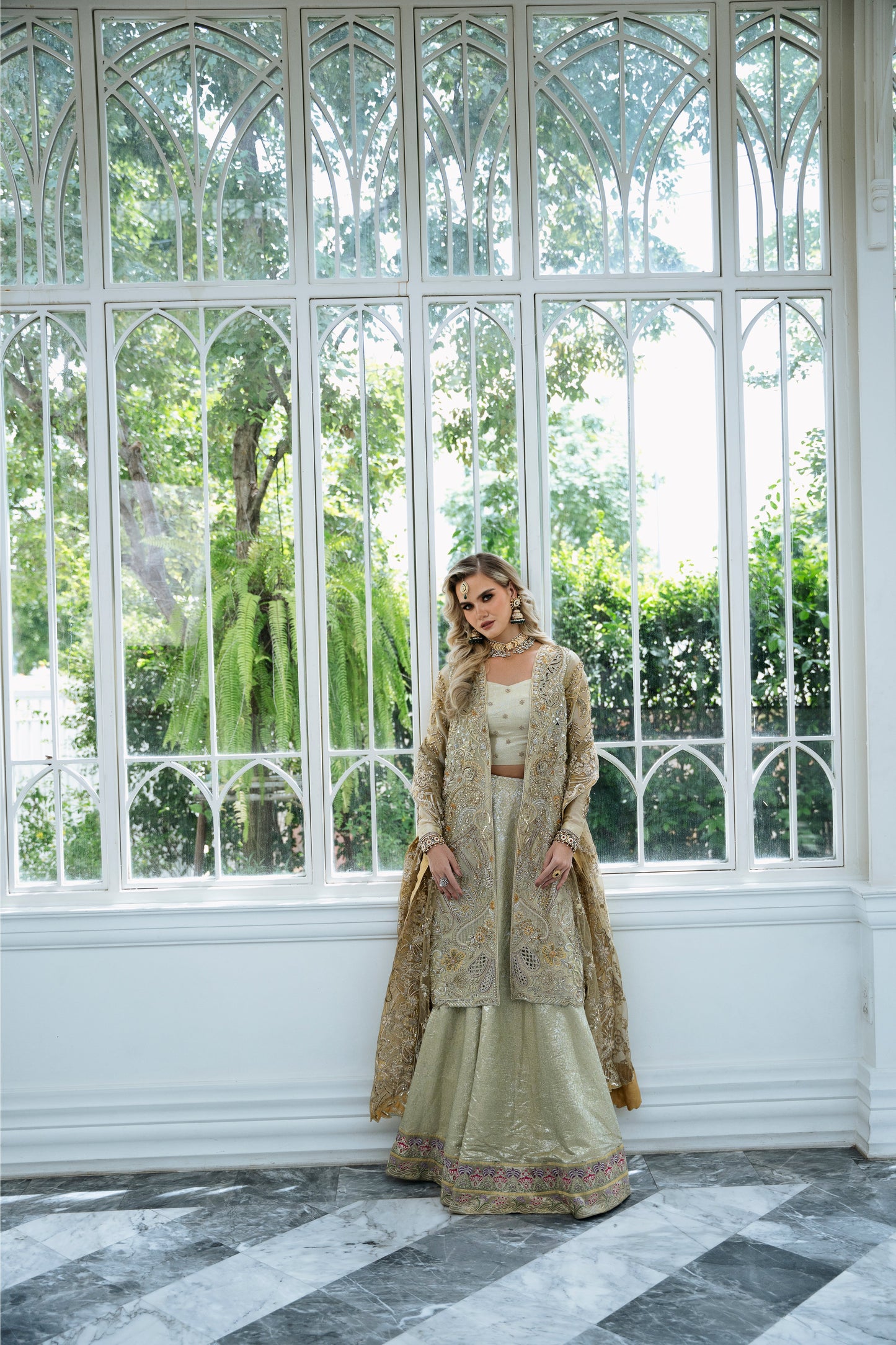 Model wearing Marigold from Mysie by Tahira, a golden-hued ensemble with intricate embroidery, ideal for Pakistani luxury pret in the UK.