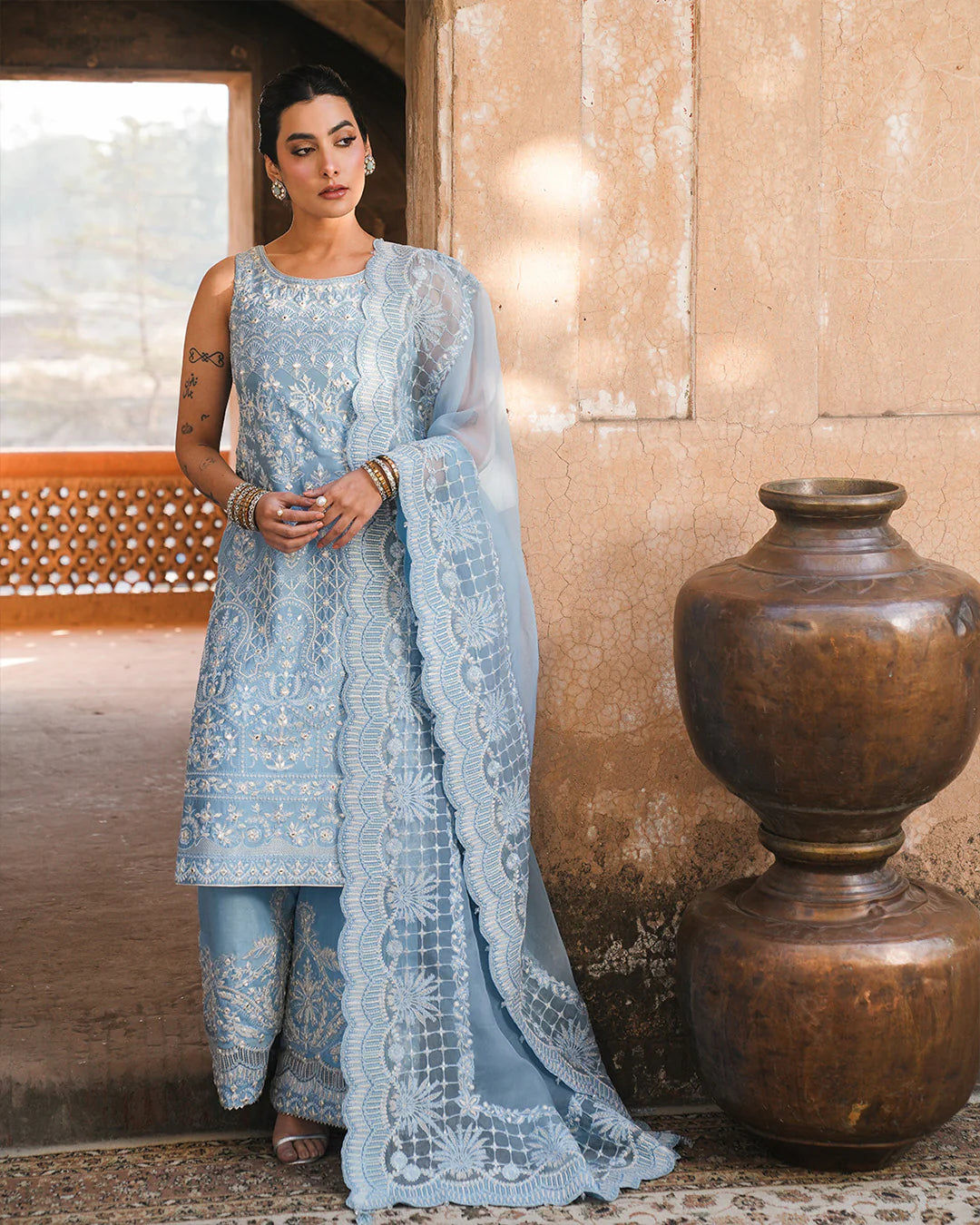 Model wearing powder blue Faiza Saqlain Yulia outfit with intricate embroidery and scalloped dupatta, ideal for Pakistani luxury pret in UK.